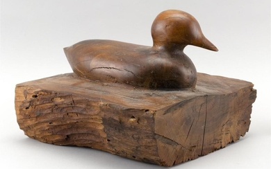 CARVED WOODEN DUCK-FORM DOORSTOP Carved from a single piece of hardwood. Height 11". Length 12.75". Width 12.5".