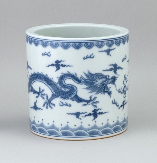 CHINESE BLUE AND WHITE PORCELAIN BRUSH POT With a five-clawed dragon design. Six-character Kangxi mark on base. Height 7". Diameter 7".