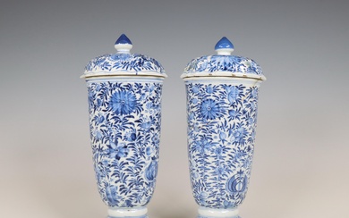 China, a pair of blue and white porcelain beaker vases and covers, Kangxi period (1662-1722)