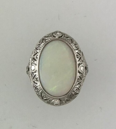 Cushion ring in white gold 750°/°°° and platinum set with an opal cabochon in a leafy setting of diamonds alternating with roses, circa 1935, (crack),Finger size 51, Gross weight: 5,6g