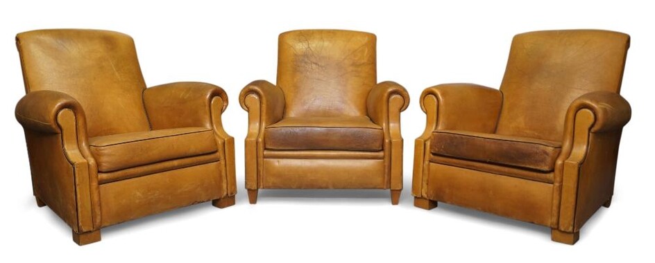 Designer Unknown, Three club armchairs, 20th century, Tan leather, black piping, beech feet, Each 88cm high, 85cm wide