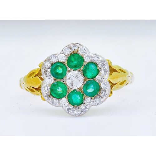 EMERALD AND DIAMOND CLUSTER RING, set with a central diamond...