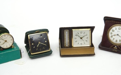 FOUR VINTAGE TRAVEL ALARM CLOCKS, INCLUDING A CREDOS ALARM CLOCK WITH A GREEN ENAMEL BODY IN A GREEN LEATHER CASE, A JUNGHANS GERMAN...
