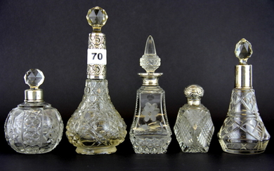 Five hallmarked silver cut glass perfume bottles, tallest H. 21cm.