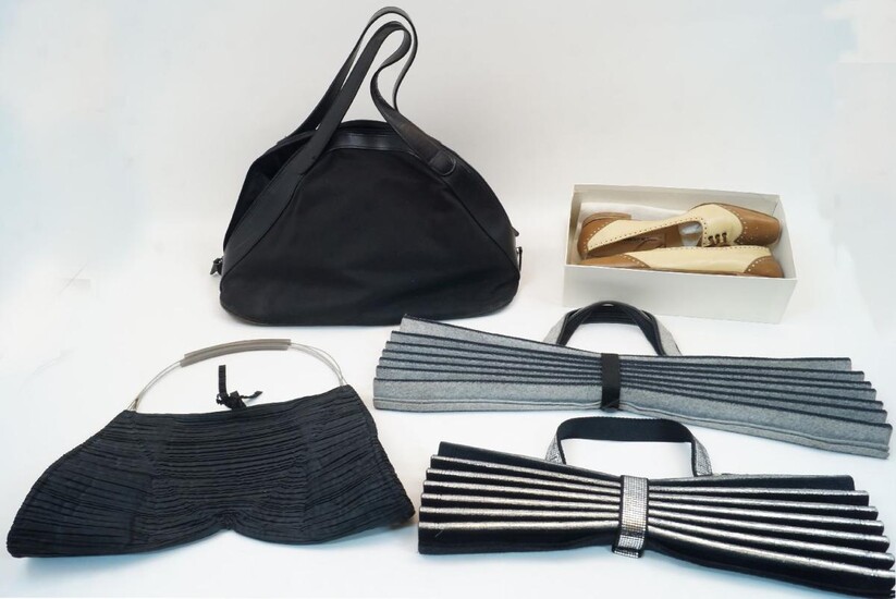 Issey Miyake: two 'Accordion' pleated bags, one in grey felt and one in black and silver felt, each with fabric and metal clasp, approximately 47cm x 54.5cm and 37cm x 40cm at full extension, together with a black canvas and leather trim holdall...