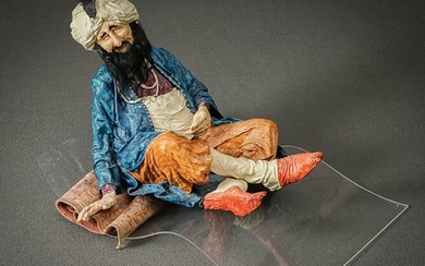 Kay Ritter (American b. 1950), Man on Flying Carpet, Painted Papier Mache and Mixed Media on Acrylic Stand Sculpture