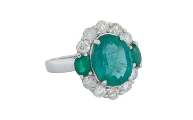 Lady's 14K White Gold Emerald and Diamond Dinner Ring, with an oval 4.16 carat emerald atop a border