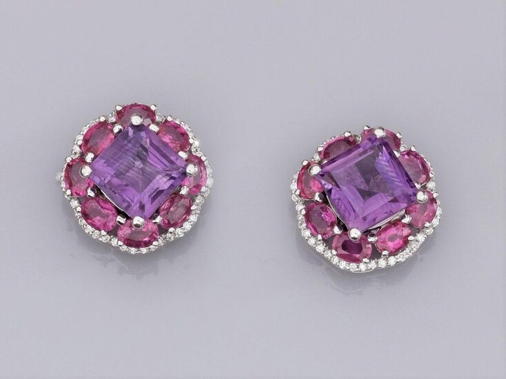 Pair of 18K white gold earrings set with square amethysts (about 3 cts each), surrounded by oval pink rubies and brilliant-cut diamonds. 9.4 g. Width: 1.5 cm. Eagle's head hallmark