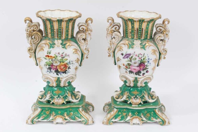 Pair of 19th century French porcelain vases, of baluster form with scrollwork handles and base, painted with floral sprays on a green gilt ground, 26cm height