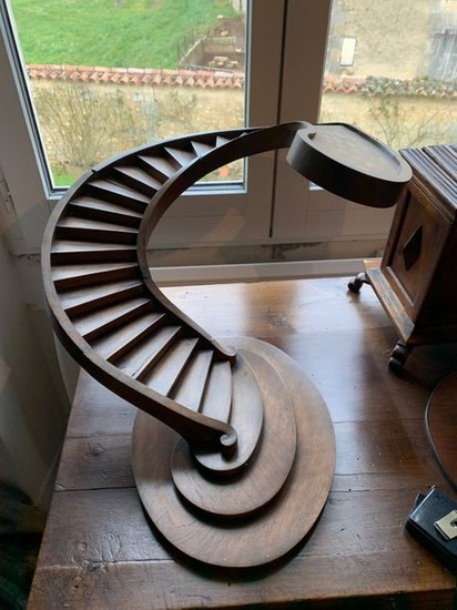 Screwed staircase in fruit wood. On a rounded...