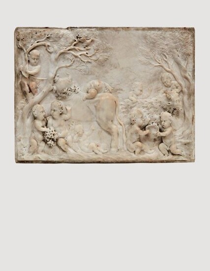 Sculpted marble PLATE in high relief representing a bacchanal of nine children in a wooded landscape playing with a goat and a bovid, a second goat visible behind a tree at the left end. In the foreground, two children fighting over a bunch of grapes...