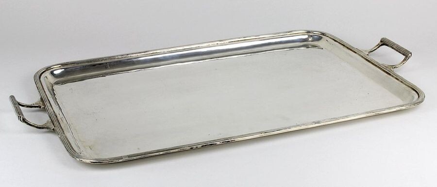 Silver tray with handles, made from 900 silver, probably Italy 2nd half of the 20th century, smooth simple rectangular form with rounded corners, rim and handles, profiled, 48 x 28.5 cm (with handles), hallmarked K 900 B in diamond, weight: 1175 g...