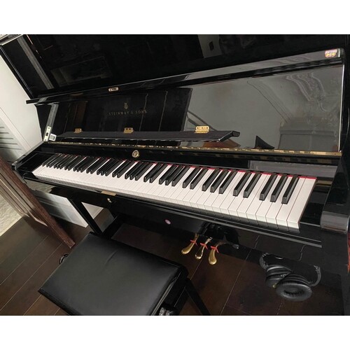 Steinway (c2003) A Model K upright piano in a bright ebonise...