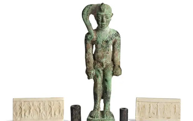 Two ancient near Eastern seals and a bronze figure of Horus, the...