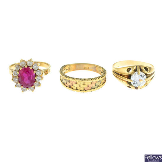 Two gem-set rings and a further ring.
