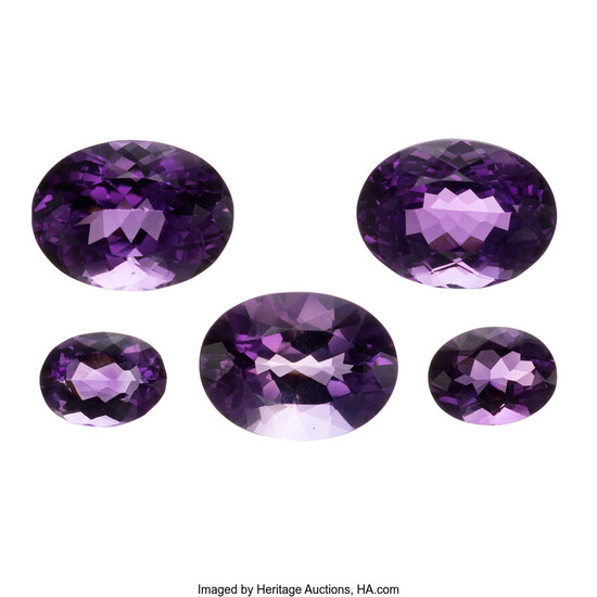 Unmounted Amethysts The lot includes five oval-shaped amethysts measuring...