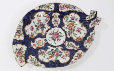 Worcester cabbage leaf dish, circa 1770, painted with panels of flowers with gilt scrollwork borders, on a blue scale ground, seal mark to base, 26cm long