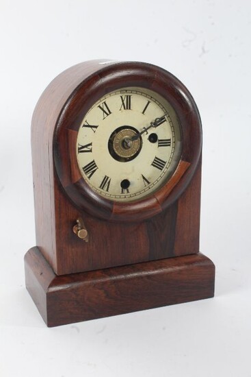 19th century rosewood mantel clock, of arched form, having a single glazed door, 24cm tall