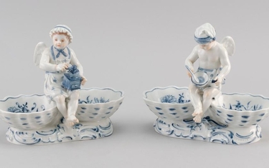 PAIR OF MEISSEN "BLUE ONION" PATTERN PORCELAIN FIGURAL SALT OR SWEETMEAT DISHES Modeled with male and female cherubs dressed as cook...