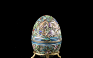 A silver, polychrome cloisonné enamel egg. Spurious marks: Moscow 1908-1927 and P. Ovchinnikov (cm 9.5 ca. without the stand) (gr...