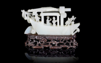 A white jade carving of a sampan with figures