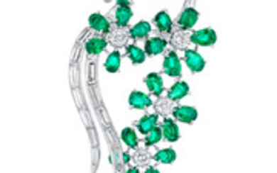 A diamond and emerald brooch