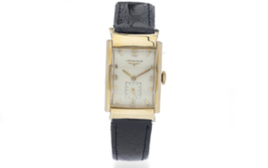 Longines. A Gilt Rectangular Wristwatch with faceted cerved front