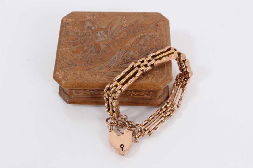 9ct rose gold gate bracelet with padlock clasp, within a small carved wood trinket box