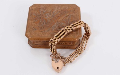 9ct rose gold gate bracelet with padlock clasp, within a small carved wood trinket box