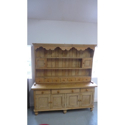 A 19th century and later stripped pine dresser with an open ...
