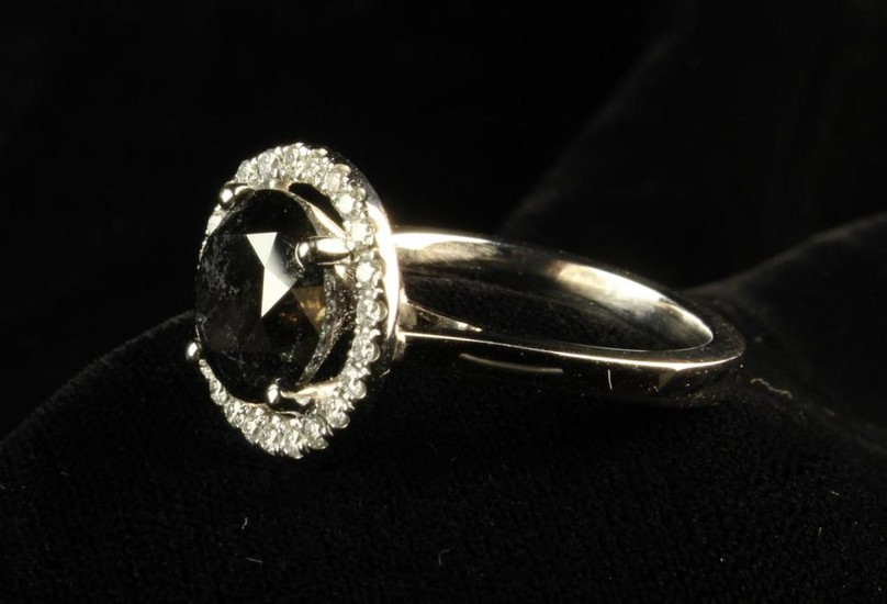 A 4.19 Carat Natural Fancy Black Diamond Ring. The round brilliant cut stone in a claw setting withi