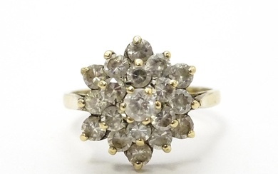 A 9ct gold ring set with diamonds in a floral cluster settin...