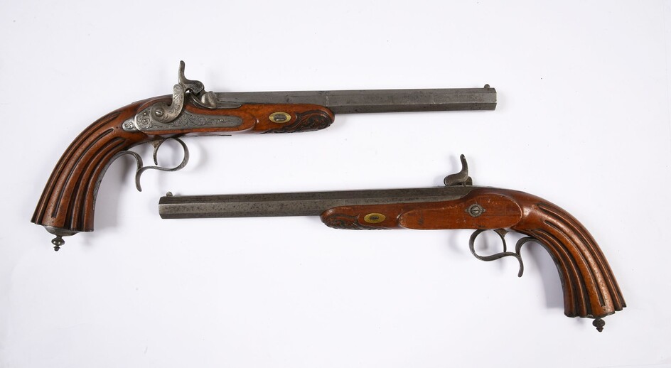 A BEAUTIFUL PAIR OF DUEL PISTOLSOR PERCUSSION COMBAT PISTOLS.Octagonal barrels with rifled bore, numbered 1 and 2. Finely engraved locks and fittings. Short moulded shafts and fluted stocks. Second part of the 19th century.L. 43 cm. VERY GOOD...