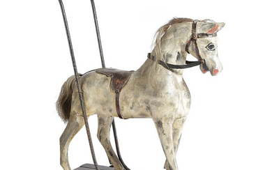 A CARVED AND PAINTED PINE CHILD'S PULL-ALONG TOY HORSE