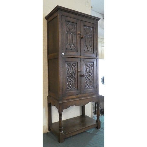 A Carved Oak Side Cabinet with Panelled Doors, Stretcher She...