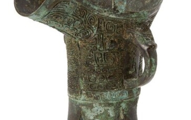 A Chinese archaic bronze ritual wine vessel, jue, Shang dynasty-style,...