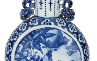 A Chinese blue and white moon flask, 19th century, painted to each side with a scholar and attendant on a prunus blossom ground, the handles pierced and moulded as pine branches, 21.5cm high 十九世紀 青花開光繪人物山水圖紋扁壺