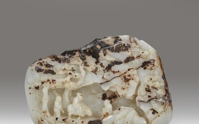 A Chinese carved white and dark brown jade "Mountain"
