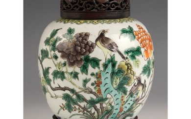 A Chinese porcelain famille vert ginger jar, cover, and stan...