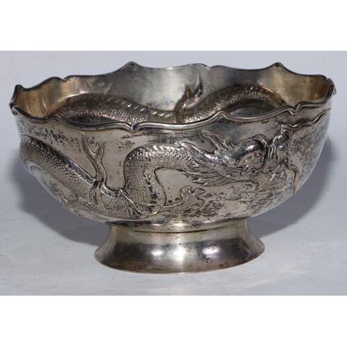 A Chinese shaped circular pedestal bowl, chased with a drago...