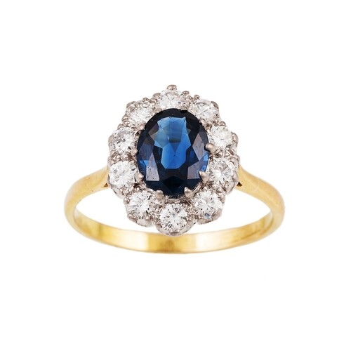 A DIAMOND AND SAPPHIRE CLUSTER RING, the oval sapphire to a ...