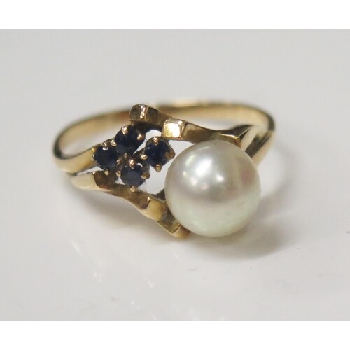 A Five Stone Pearl and Sapphire Ring in an unmarked gold set...