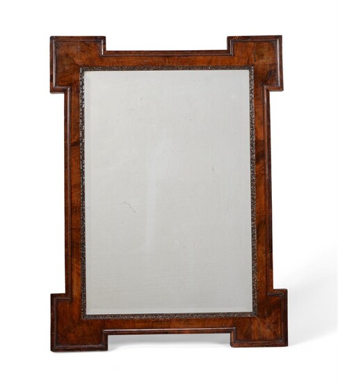 A GEORGE II WALNUT AND PARCEL GILT WALL MIRROR, IN THE MANNER OF WILLIAM KENT, CIRCA 1735