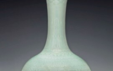 A RARE AND EXCEPTIONAL CELADON-GLAZED RELIEF-DECORATED BOTTLE VASE, QIANLONG SIX-CHARACTER SEAL MARK IN UNDERGLAZE BLUE AND OF THE PERIOD (1736-1795)
