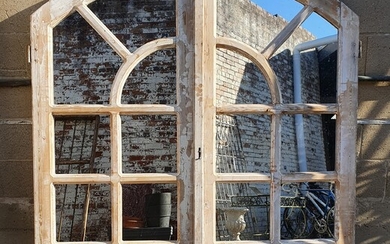 A RUSTIC DOME-TOP TWO PIECE MIRRORED WINDOW