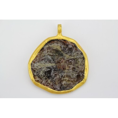 A Roman Glass Pendant mounted in a Gilt Metal Frame.