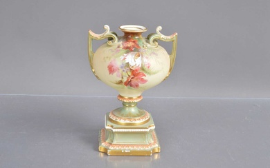 A Royal Worcester twin handled pedestal urn shape blush ivory vase