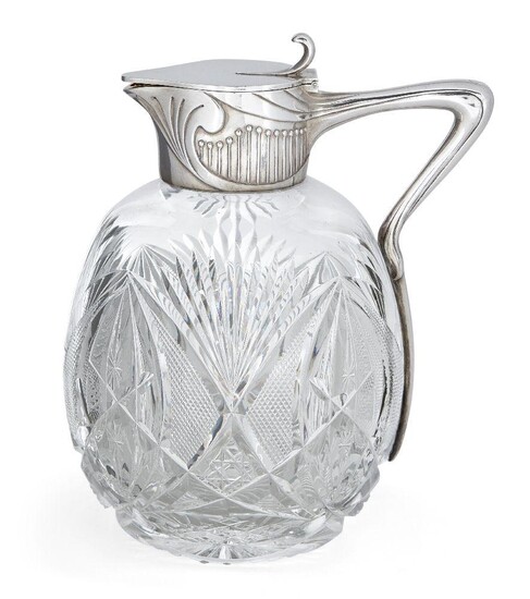 A Russian silver mounted cut glass decanter, Grachev Brothers, St Petersburg, assay master Yakov Lyapunov (1899-1903), designed with a flattened oviform cut glass body to a silver collar chased with Art-Nouveau motifs, the stylised foliate handle...