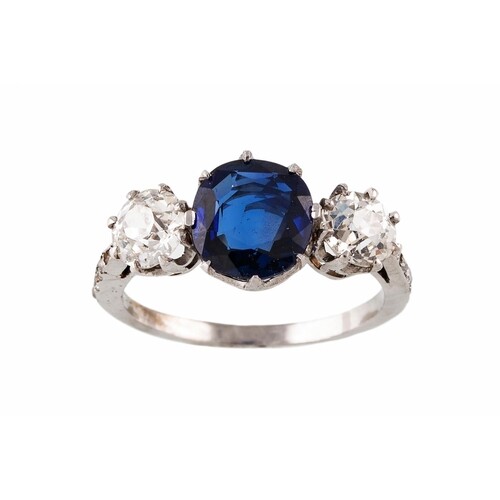 A SAPPHIRE AND DIAMOND THREE STONE RING, the oval sapphire f...