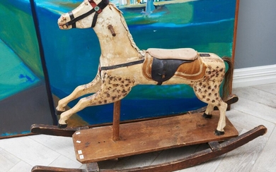A VINTAGE PAINTED WOODEN ROCKING HORSE WITH ORIGINAL HORSE HAIR TAIL (OLD BORER DAMAGE AND LOSSES OVERALL) (90H X 110W X 34D CM)